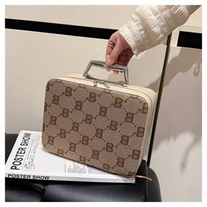 Vintage monogram cosmetic case with metal handle and structured design, elegant travel makeup bag.