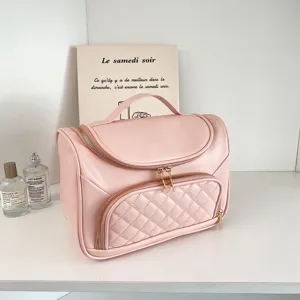 Pink PU leather cosmetic bag with top handle and quilted front pocket for travel and daily use.