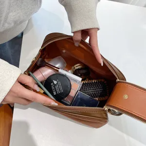 Large capacity brown cosmetic bag travel makeup pouch portable toiletry organizer with zipper.