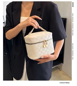 White PU leather cosmetic bag with top handle, elegant square vanity case for women storage.