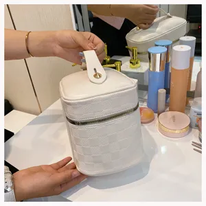 White checkered PU leather cosmetic bag, portable vanity case with handle and zipper details.