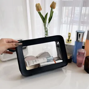 Clear PVC travel cosmetic bag with black PU leather trim, perfect for daily makeup storage.