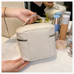 White checkered PU leather cosmetic bag with handle, portable travel makeup storage pouch.