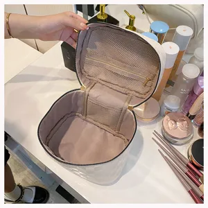 Detailed view of white PU leather cosmetic bag interior with mesh zipper pocket.