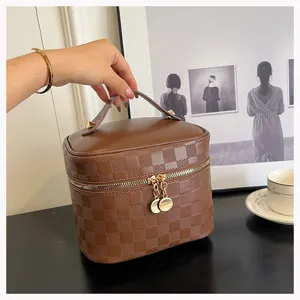 Brown checkered cosmetic bag detail, pu leather vanity case with gold zipper and handle.