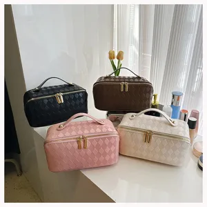 Detailed view of the stylish quilted PU leather cosmetic bag with large capacity and handle.