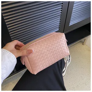 Pink woven leather cosmetic bag, portable luxury clutch makeup pouch for women and girls storage.