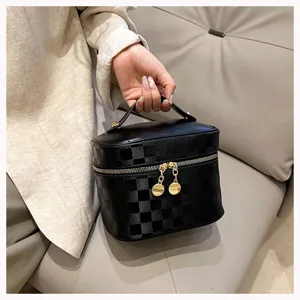 Black PU leather cosmetic bag with chic checkerboard pattern, portable vanity makeup case.