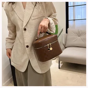 Brown PU leather vanity bag, stylish checkered makeup case with top handle for daily travel storage.