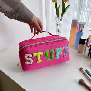 Pink nylon cosmetic bag with colorful fuzzy letters, large capacity travel makeup organizer.