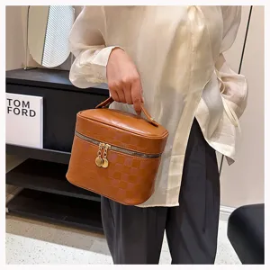 Brown checkered PU leather cosmetic bag featuring secure gold-tone zippers and handle.