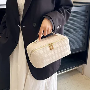 Quilted PU leather cosmetic bag with large capacity, top handle and secure double zipper.