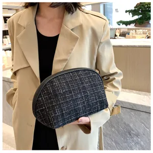 Classic tweed half-moon cosmetic bag, portable zip makeup pouch for travel and daily storage.