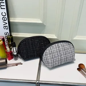 Classic tweed half-round cosmetic bag, stylish portable makeup storage pouch for travel.