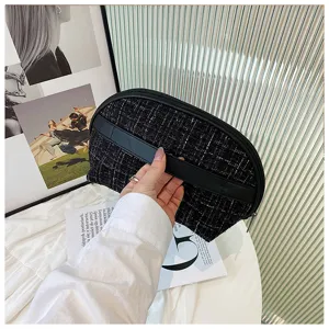Black tweed cosmetic bag with PU leather handle, stylish half-moon makeup pouch for travel.