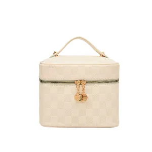 White PU leather cosmetic bag with chic checkerboard debossed pattern and gold hardware.