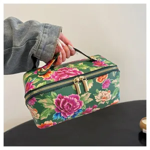 Detailed view of Chinese traditional floral PU leather cosmetic bag with secure double zippers.