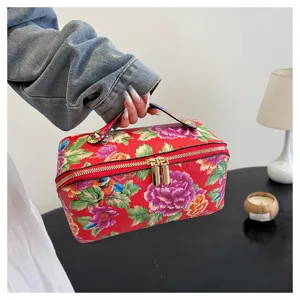 Detail shot of Chinese style peony floral PU leather cosmetic storage bag with handle.