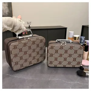 Detailed view of brown monogram cosmetic case set, portable vanity box with metallic handle.
