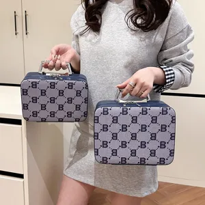 Portable hard cosmetic case with retro letter B pattern and metal handle for travel use.