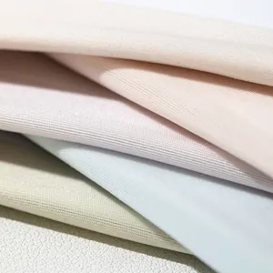 Detail close-up of women's solid color invisible boat socks fabric in soft pastel cream mousse tones.