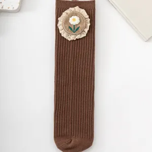 Girls brown ribbed mid-tube socks with cute floral lace embroidery and sweet style.