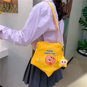 Kids cute star canvas shoulder bag with cartoon print and plush pendant, casual crossbody bag.