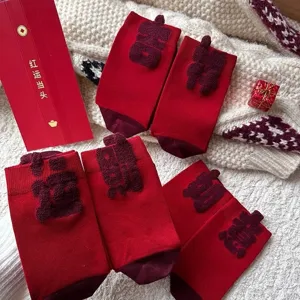 Red festive mid-tube socks with lucky 3D Chinese characters, cozy New Year gift knit style.