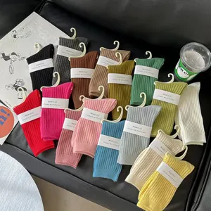 Solid color ribbed mid-tube cotton socks for women, versatile stacked long wear.