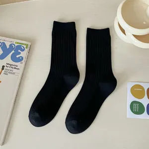 Solid color black ribbed crew socks for women, versatile cotton mid-calf daily wear.