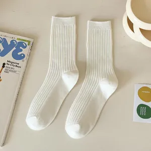 Solid color ribbed cotton mid tube socks for women, comfortable versatile white socks.