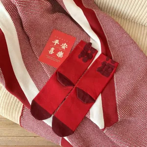 Red mid-tube socks for Chinese New Year, festive cotton hosiery with lucky 3D text.