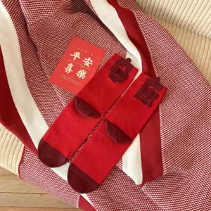 Red mid-tube socks for Chinese New Year festive wear with lucky text and cozy knit design.