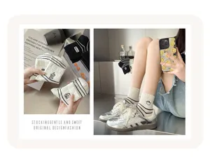 Detailed close-up view of black and white striped cotton socks with cute embroidery details.