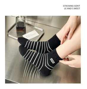 Black and white striped cotton socks for women, breathable mid-tube casual wear with cute embroidery detail.