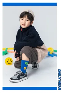 Detailed shot of kids mid-tube socks featuring smiley face design and trendy style in daily wear.