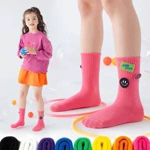 Kids mid-tube socks with cute smiley face and letter patches, comfortable daily wear multi-color