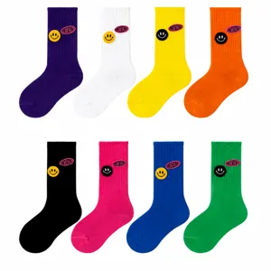 Children's mid-calf socks featuring fun smiley patches and letter designs, multi-color styles.