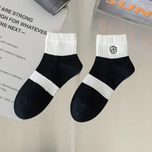 Black and white striped crew socks with cute floral embroidery, breathable cotton for spring.