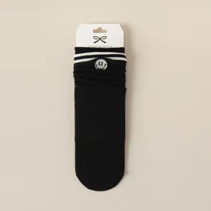 Black cotton mid-tube socks featuring cute smiley face embroidery and classic double stripes for autumn.