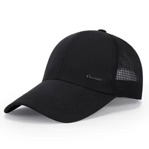 Detailed view of a black nylon baseball cap with breathable mesh and metal logo accent.