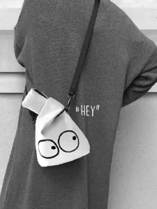 Mini canvas crossbody bag for women with big eyes cartoon design, casual shoulder handbag.