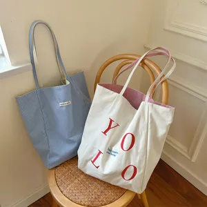 Casual canvas tote bag, stylish double-sided shoulder bag, large capacity commuting bag.