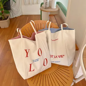 Canvas tote bag with embroidered letters, reversible casual shoulder bag for commuting daily use.