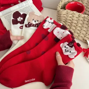 Cozy cute cartoon fuzzy winter socks detail, warm red and white plush style for women.