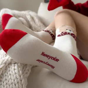 Cozy winter women's cotton crew socks with cute bear design and red contrast toe and heel.