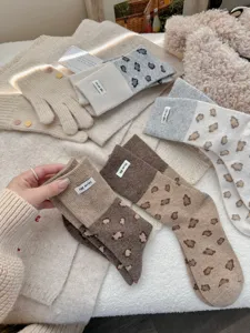 Close-up detail of cozy wool blend socks featuring stylish leopard print and chic cloth label.