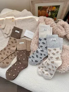 Cozy winter thick wool blend women socks featuring cute leopard pattern and chic color block design.