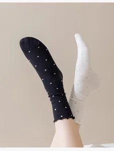 Close up view of cute polka dot lettuce edge slouch socks women cotton daily wear cute style detail