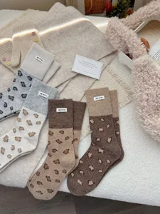 Cozy winter wool socks featuring a stylish color-block design and chic leopard print.